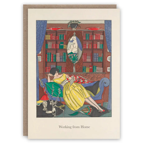 Greeting card with called working from home featuring illustration of a woman in a full skirted yellow dress sitting in a room with bookshelves and a mirror, reading on a sofa